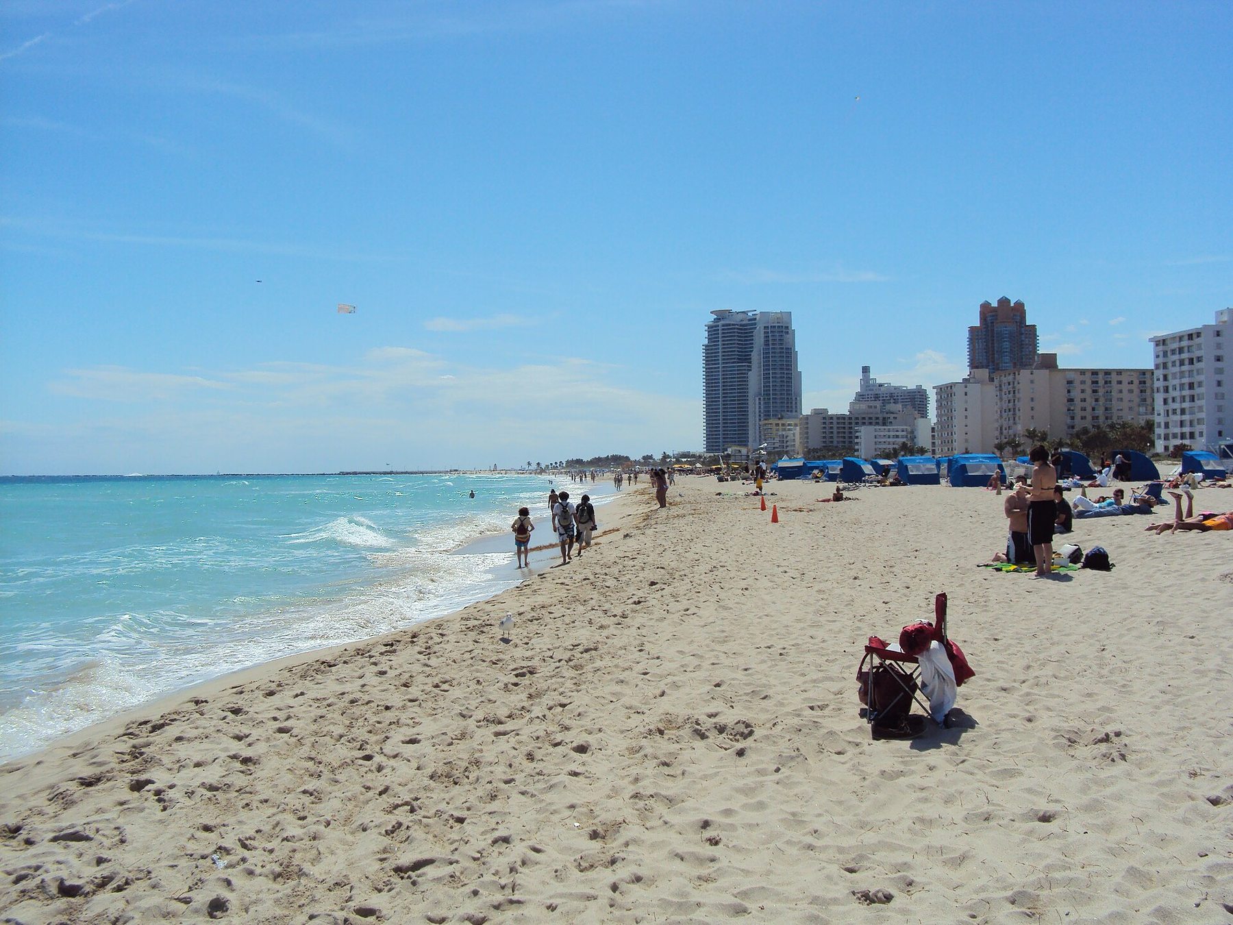 Turquoise ocean, beachgoers and the South Beach shoreline in Miami Beach.